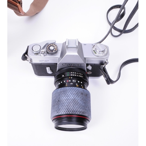 228 - Canon - A vintage mid 20th century Canon FP 35mm SLR camera. The camera in silver colourway, alongsi... 