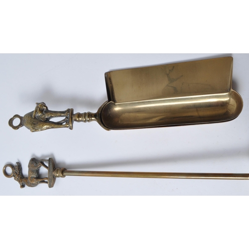 239 - 20th century brass fireside implements, comprised of dust pans, brushes, pokers, and shovels. Each t... 