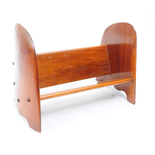 244 - A 20th century walnut wood book trough. The trough having a single bookshelf, with shaped rounded si... 