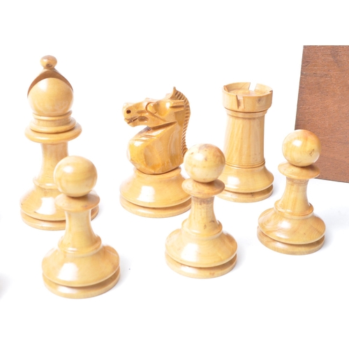 251 - A vintage 20th century turned wooden chess set. Having all thirty two pieces, in Staunton pattern. H... 