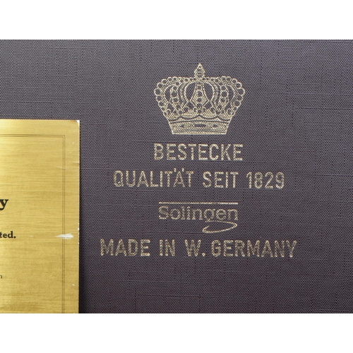 254 - Solingen - West German 1829 23-4 carat gold plated twelve setting cutlery canteen with certificate o... 