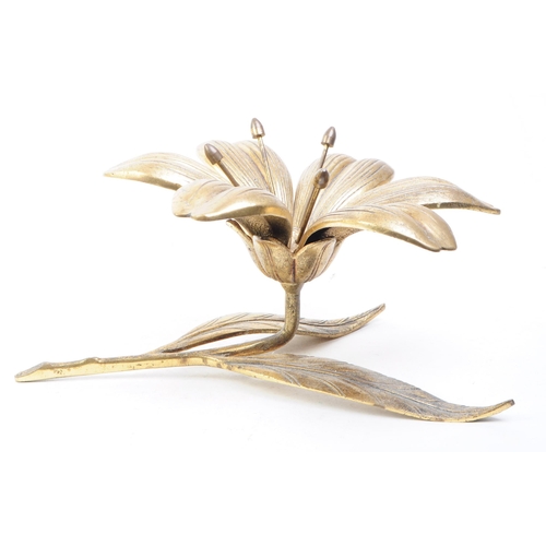 256 - A vintage mid 20th century brass floral lily ashtray. The ashtray in the form of a lily flower, with... 