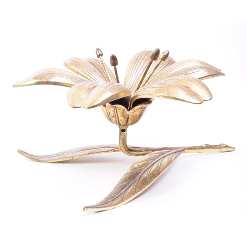 256 - A vintage mid 20th century brass floral lily ashtray. The ashtray in the form of a lily flower, with... 