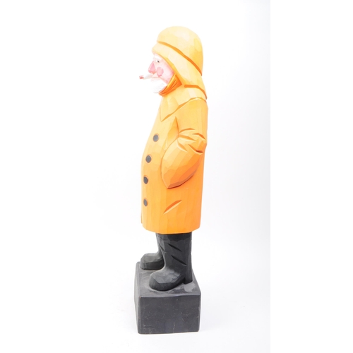 258 - Bounty Arts, Dartmouth. Hand carved wooden fisherman on black plinth base. Standing position with ci... 