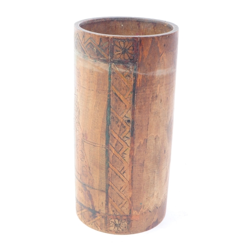 262 - A late 19th / early 20th century carved bamboo pen pot / vase. Having carved and painted scene to si... 