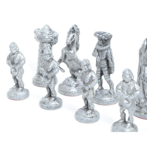 269 - 20th century cast metal full chess set comprised of medieval style figures. Largest piece measuring ... 