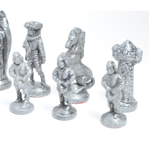 269 - 20th century cast metal full chess set comprised of medieval style figures. Largest piece measuring ... 