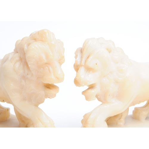 292 - Two 19th century alabaster stone carved lion statues / sculptures. (AF) Measuring approx. 11.5cm x 1... 