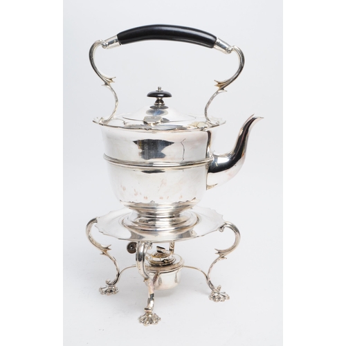 309 - A 19th century silver plated spirit kettle. The spirit kettle base having scrolled supports over paw... 