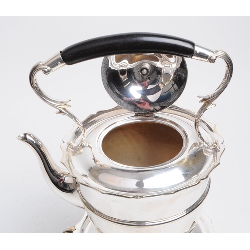 309 - A 19th century silver plated spirit kettle. The spirit kettle base having scrolled supports over paw... 