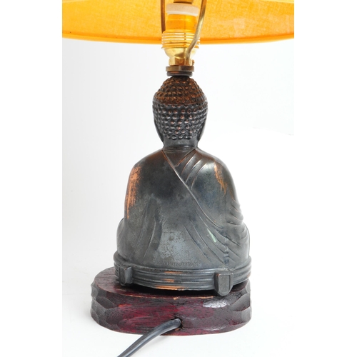 310 - 1950s Japanese copper Buddha shaped lamp base with yellow shade. Buddha mounted on a carved wooden b... 