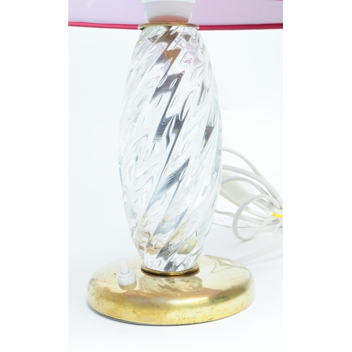 311 - An Italian 1960s Murano clear glass and brass based table lamp with a red conical shade. Measuring a... 