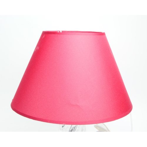 311 - An Italian 1960s Murano clear glass and brass based table lamp with a red conical shade. Measuring a... 