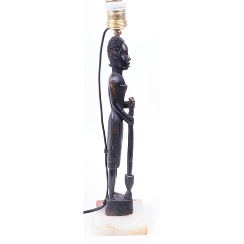 312 - 20th century African tribal carved hardwood table lamp raised on a square Onyx plinth base. Measurin... 