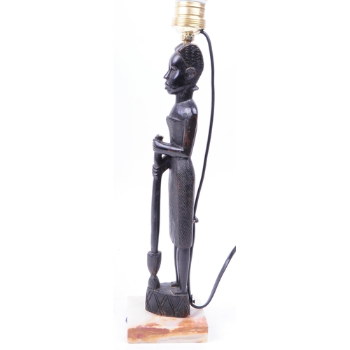 312 - 20th century African tribal carved hardwood table lamp raised on a square Onyx plinth base. Measurin... 