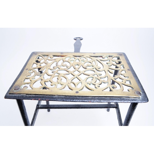 329 - A 19th century Victorian brass and iron fire cooking trivet / footman. Brass pierced scroll top with... 