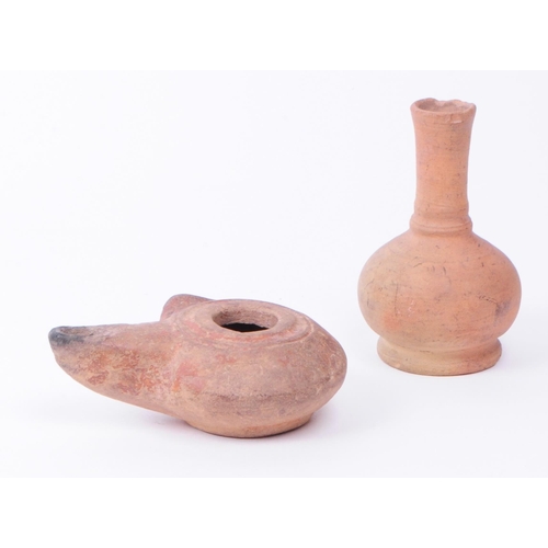 337 - Roman clay pottery artifacts comprised of an oil lamp and a small vase. Largest piece measuring appr... 