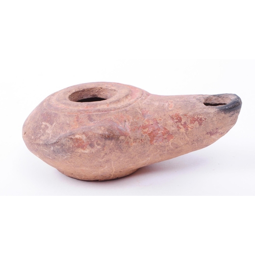 337 - Roman clay pottery artifacts comprised of an oil lamp and a small vase. Largest piece measuring appr... 