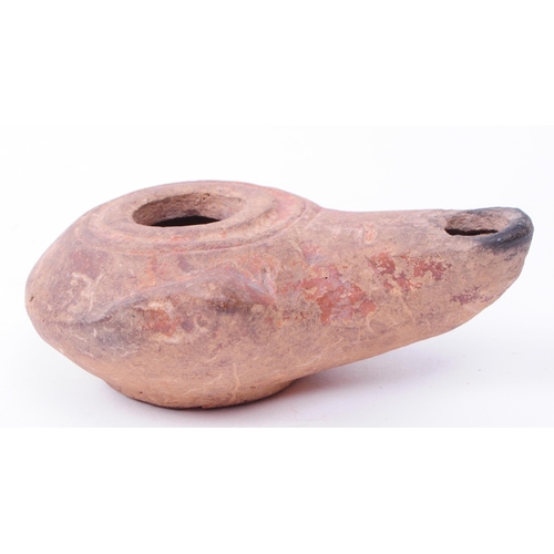 337 - Roman clay pottery artifacts comprised of an oil lamp and a small vase. Largest piece measuring appr... 