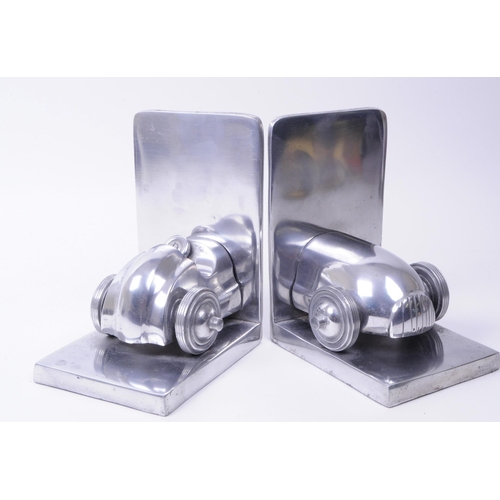 340 - Modern cast metal vintage racing car bookends. An old open top Formula One racing car split into two... 