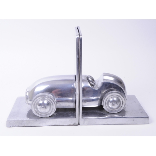 340 - Modern cast metal vintage racing car bookends. An old open top Formula One racing car split into two... 