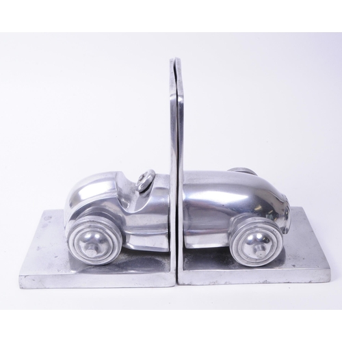 340 - Modern cast metal vintage racing car bookends. An old open top Formula One racing car split into two... 