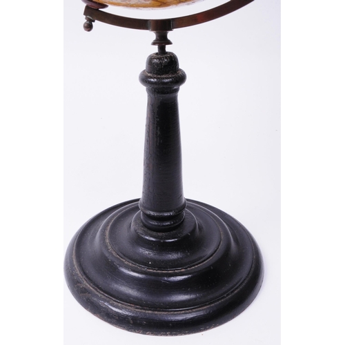 347 - 20th century desktop world globe with brass arm and ebonised turned wooden stand. Makers sticker tit... 