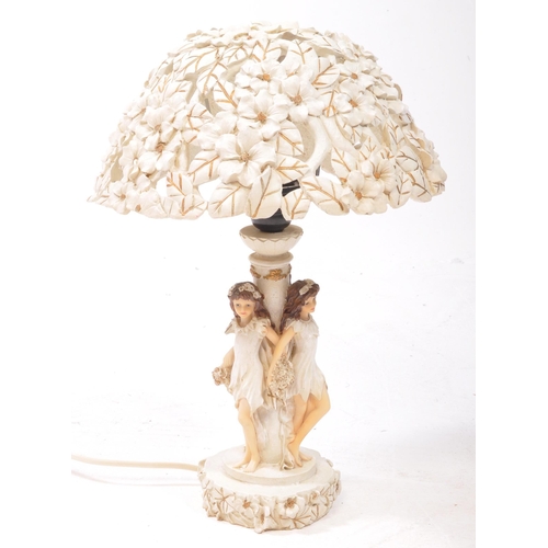 353 - Two 20th century resin table lamps, comprised of an Academy lamp decorated with three flower fairy f... 