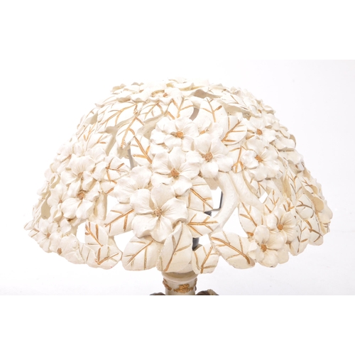 353 - Two 20th century resin table lamps, comprised of an Academy lamp decorated with three flower fairy f... 