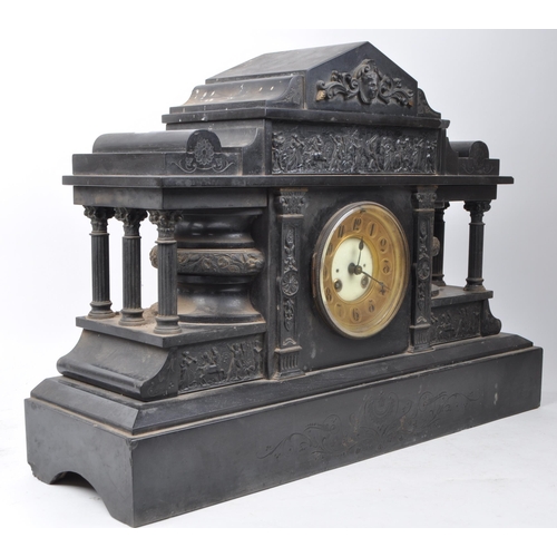 384 - A large mid 19th century black slate mantel clock of temple form with figural head to top, the stepp... 