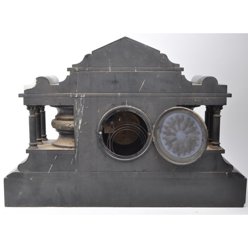 384 - A large mid 19th century black slate mantel clock of temple form with figural head to top, the stepp... 