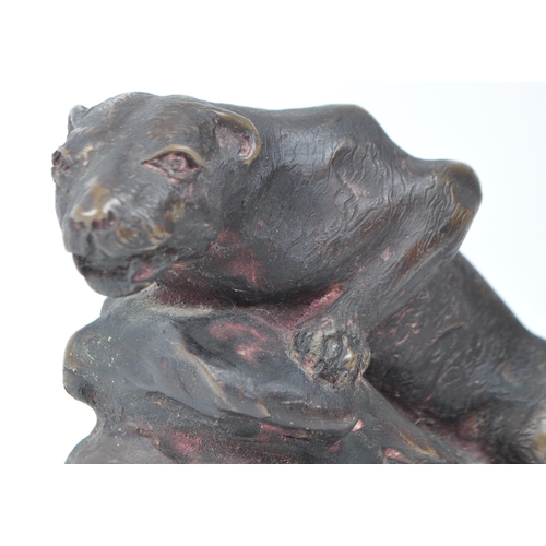 397 - After John Macallan Swan R. A. (1847-1910) A spelter bronze model of a recumbent panther on a natura... 