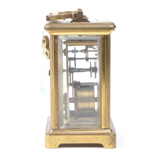 398 - 20th brass carriage clock, with a Roman numeral chapter ring on white enamel face. Bevelled glass to... 