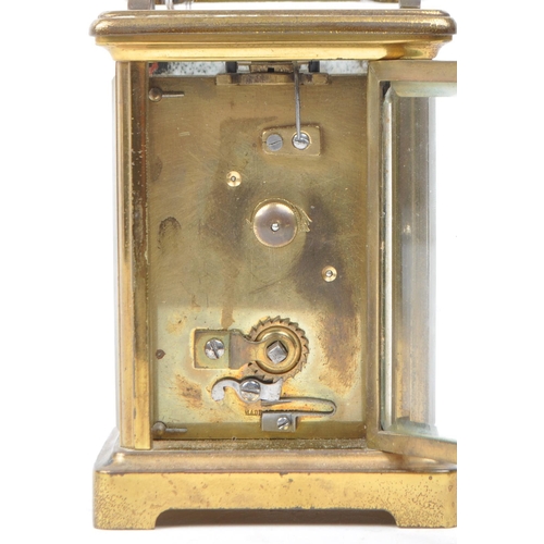 398 - 20th brass carriage clock, with a Roman numeral chapter ring on white enamel face. Bevelled glass to... 