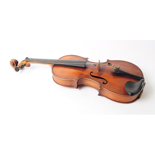 407 - An early 20th century mahogany violin. The violin having ebonised fingerboard and chinrest.