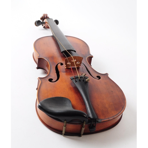 407 - An early 20th century mahogany violin. The violin having ebonised fingerboard and chinrest.