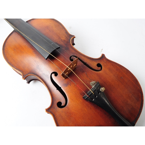 407 - An early 20th century mahogany violin. The violin having ebonised fingerboard and chinrest.