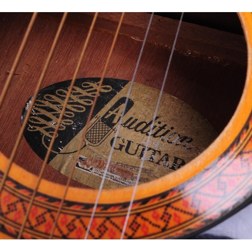 425 - A vintage 1960s Audition acoustic six string guitar with a wooden body, steel reinforced neck, plast... 