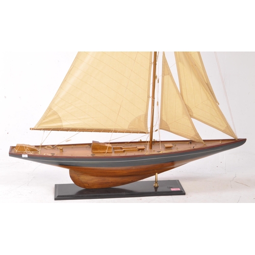 450 - A 20th century model yacht / sailing boat. Of wooden construction with a black and red painted finis... 