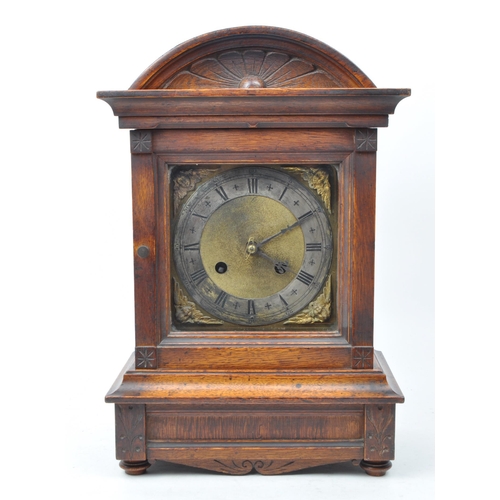 465 - An early 20th century oak cased eight day movement mantel clock. Moulded floral motif to top, with g... 