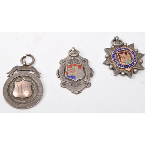 476 - A small collection of early 20th century 1920s British silver football medals. The collection to inc... 