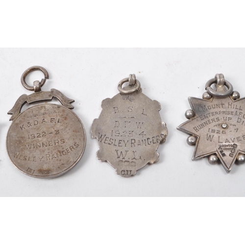 476 - A small collection of early 20th century 1920s British silver football medals. The collection to inc... 