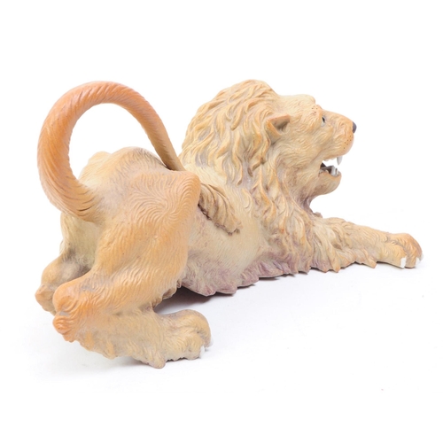 66 - A mid 20th century circa 1960s Chinese Cantonese ceramic lion figure. The lion in recumbent position... 