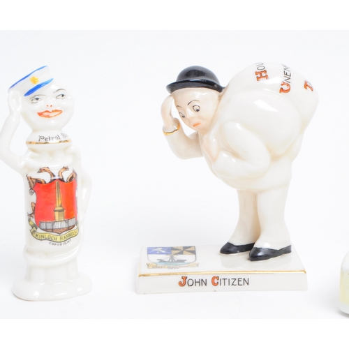 90 - A collection of four early 20th century crested china figures. Comprised of a Carlton china John Cit... 