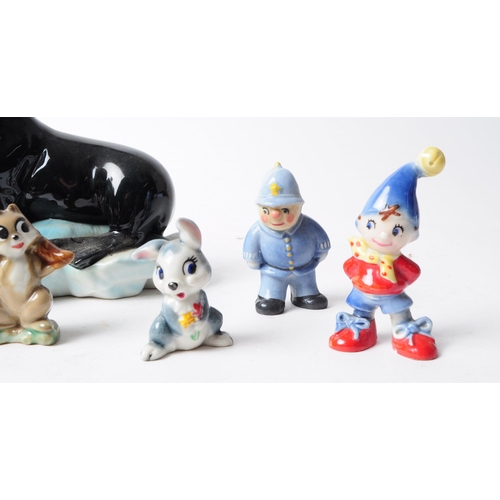 91 - Wade - Collection of 20th century pottery figurines, comprised of three noddy figures, two rabbits, ... 