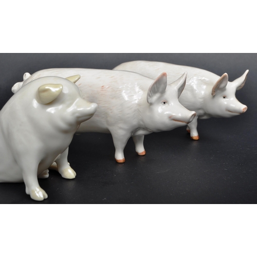 187 - Collection of five 20th century porcelain pig figurines from various makers. Comprised of a Belleek ... 