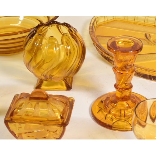 32 - Collection of mid century amber glass dressing table set pieces. Comprised of a centrepiece bowl, ca... 