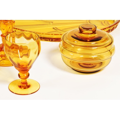 32 - Collection of mid century amber glass dressing table set pieces. Comprised of a centrepiece bowl, ca... 