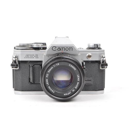 370 - Canon - A vintage 20th century circa 1980s Canon AE-1 35mm SLR camera. The camera in silver colourwa... 