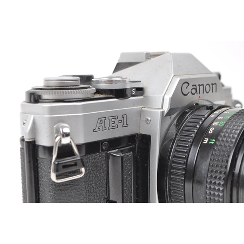 370 - Canon - A vintage 20th century circa 1980s Canon AE-1 35mm SLR camera. The camera in silver colourwa... 